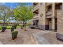 Exterior shot of a building entrance highlighting a well-kept garden and walkway at 10136 E Southern Ave # 1074, Mesa, AZ 85209