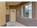 Close up of the unit door and window with tan paint and a visible address marker at 10136 E Southern Ave # 1074, Mesa, AZ 85209