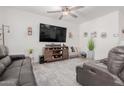Cozy living room with a large TV, wooden entertainment center, and comfortable seating at 10138 W Wood St, Tolleson, AZ 85353