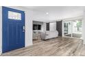 Bright living room with wood-look flooring and modern decor including shiplap wall and sliding barn door at 1038 N 78Th Pl, Scottsdale, AZ 85257