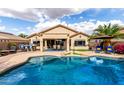 Relaxing backyard with a shimmering pool, patio, outdoor kitchen, and desert landscaping for entertaining friends and Gathering at 12526 S 176Th Ave, Goodyear, AZ 85338
