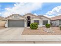 Attractive single-story home boasting a large two car garage and desert landscaping at 1289 E Baker Dr, San Tan Valley, AZ 85140