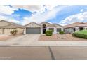 Well-maintained single-story home with a spacious driveway and low-maintenance front yard at 1289 E Baker Dr, San Tan Valley, AZ 85140