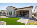 Backyard featuring a covered patio, artificial turf and gravel landscaping at 156 E Leverenz Ave, Queen Creek, AZ 85140