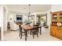 Cozy dining area with a table and chairs, seamlessly connected to the living room and outdoor patio at 156 E Leverenz Ave, Queen Creek, AZ 85140
