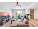 Inviting living room with tile floor entry and ceiling fan, showcasing an open layout at 1643 W Harmont Dr, Phoenix, AZ 85021