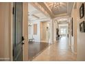 Spacious foyer boasts elegant lighting, tile flooring, and seamless transitions to living spaces at 17985 W Jojoba Rd, Goodyear, AZ 85338
