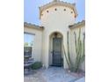 Inviting front door with a turret feature, desert landscaping, and water fountain at 17985 W Jojoba Rd, Goodyear, AZ 85338