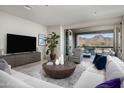Cozy living room with sliding glass doors to balcony, offering stunning mountain views and ample natural light at 18720 N 101St St # 3006, Scottsdale, AZ 85255