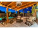 Inviting covered patio featuring comfortable seating, lush greenery, and a sparkling pool at 19440 N 12Th St, Phoenix, AZ 85024
