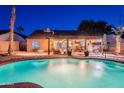 Sparkling pool with a well-manicured yard, covered patio, and ample space for outdoor entertaining at 19440 N 12Th St, Phoenix, AZ 85024