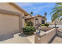Close up shot of the desert landscaped home's exterior, highlighting the well-maintained garden and neutral color palette at 19791 N 86Th Dr, Peoria, AZ 85382