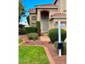 Inviting front entrance with manicured landscaping, a tile walkway, and a double door, creating a welcoming first impression at 21538 N 59Th Ln, Glendale, AZ 85308