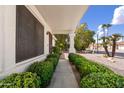 Inviting walkway lined with manicured bushes leading to the front door of this lovely home at 2736 Leisure World --, Mesa, AZ 85206