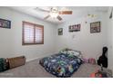 Cozy bedroom features neutral carpet, ceiling fan, and bright natural light at 29431 N 23Rd Dr Dr, Phoenix, AZ 85085