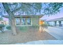 View of home with a tree in the front yard, brick accents, and a paver driveway at 3153 E Ivanhoe St, Gilbert, AZ 85295