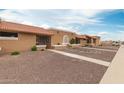 Charming exteriors of a row of single-story homes with tidy rock landscaping and walkways at 317 W Tonopah Dr # 2, Phoenix, AZ 85027