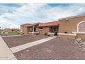 View of the lovely, single-story house with rock landscaping and a tidy sidewalk at 317 W Tonopah Dr # 2, Phoenix, AZ 85027