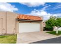 The garage features a large white door and a charming terracotta tile roof at 3345 E University Dr # 73, Mesa, AZ 85213