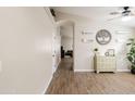 Open hallway with wood-look floors, decorative accents, and view into the living area at 34195 N Alison Dr, San Tan Valley, AZ 85144