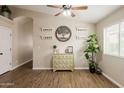 Open living area featuring wood-look floors, ceiling fan, decorative shelves and a lush house plant at 34195 N Alison Dr, San Tan Valley, AZ 85144