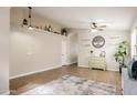 Bright living room with stylish decor, wood-look floors, ceiling fan, and decorative shelves at 34195 N Alison Dr, San Tan Valley, AZ 85144