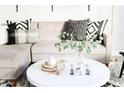 Close-up of a stylish sectional and coffee table, adorned with decorative items and pillows at 3500 N Hayden Rd # 2103, Scottsdale, AZ 85251