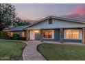 Inviting home showcasing a brick pathway, lush lawn, and classic architectural details during twilight at 370 E Redfield Rd, Chandler, AZ 85225