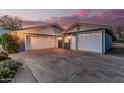 Spacious two-car garage with white doors, complemented by matching blue siding and gable accents at 370 E Redfield Rd, Chandler, AZ 85225