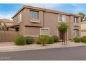 Inviting townhome with a well-kept exterior, featuring manicured bushes and neutral tones at 4002 E Melinda Ln, Phoenix, AZ 85050