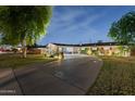 Charming brick home featuring a long driveway, covered parking and meticulously landscaped surroundings at 4408 N 28Th Pl, Phoenix, AZ 85016