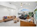 Bright living room with high ceilings, modern decor, and seamlessly connected to the kitchen and dining area at 4408 N 28Th Pl, Phoenix, AZ 85016