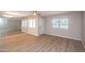 Well-lit living room boasting wood-look floors, mirror wall and ample natural light at 4502 E Carol Ave # 1, Mesa, AZ 85206