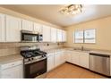 Well-equipped kitchen featuring stainless steel appliances, white cabinets, and light countertops at 504 E Racine Pl, Casa Grande, AZ 85122