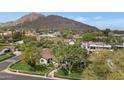 Aerial view of the property with views of nearby mountain range and surrounding community at 6102 E Calle Del Norte --, Scottsdale, AZ 85251