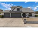 Charming home featuring a three-car garage, arched entry, and well-maintained landscaping at 6237 W Altadena Ave, Glendale, AZ 85304