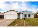 Attractive single-story home featuring a tidy lawn, two windows, and an attached two-car garage at 806 W El Alba Way, Chandler, AZ 85225