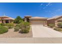 Beautiful home with a two-car garage and attractive landscaping at 9032 W Sierra Pinta Dr, Peoria, AZ 85382