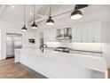 Well-lit kitchen boasts a large white island, modern appliances, and ample counter space for culinary enthusiasts at 915 W Ardmore Rd # 11, Phoenix, AZ 85041