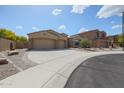 Expansive driveway leads to this single-story home with a three-car garage at 9698 S 183Rd Ave, Goodyear, AZ 85338
