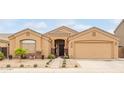Charming single-story home featuring a desert landscaped front yard and attached two-car garage at 1231 W Beacon Ct, Casa Grande, AZ 85122