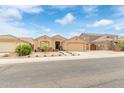 Charming single-story home featuring a desert landscaped front yard and attached two-car garage at 1231 W Beacon Ct, Casa Grande, AZ 85122