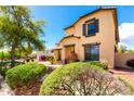 Charming two-story home with lush green landscaping, enhanced curb appeal at 13932 N 135Th Dr, Surprise, AZ 85379