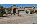 Charming single-story home with a desert-landscaped front yard and two car garage at 14214 W Ventura St, Surprise, AZ 85379