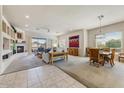 Bright and airy living area with fireplace, adjoined to a dining area and backyard patio at 15201 N Zapata Dr, Fountain Hills, AZ 85268