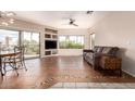 Spacious living room featuring tile floors, a ceiling fan, and sliding glass doors to a balcony at 16616 E Gunsight Dr # 114, Fountain Hills, AZ 85268