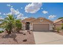 Charming home featuring desert landscaping, a spacious two-car garage, and a welcoming facade at 1806 N 108Th Ave, Avondale, AZ 85392