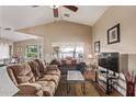 Comfortable living room featuring vaulted ceilings, lots of seating and bright, airy windows at 1806 N 108Th Ave, Avondale, AZ 85392