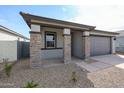 Single-story home boasting stone pillar accents and desert landscaping at 18171 W Daley Ln, Surprise, AZ 85387