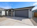 A single story home showcasing a two-car garage and desert landscaping at 18171 W Daley Ln, Surprise, AZ 85387